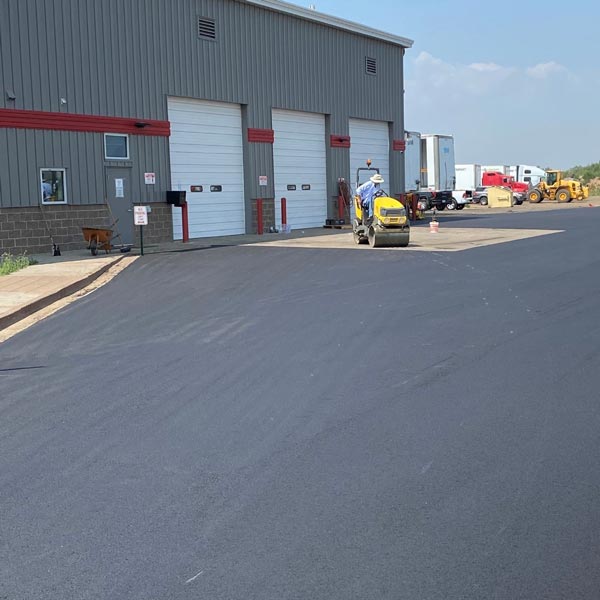 new asphalt driveway outside warehouse